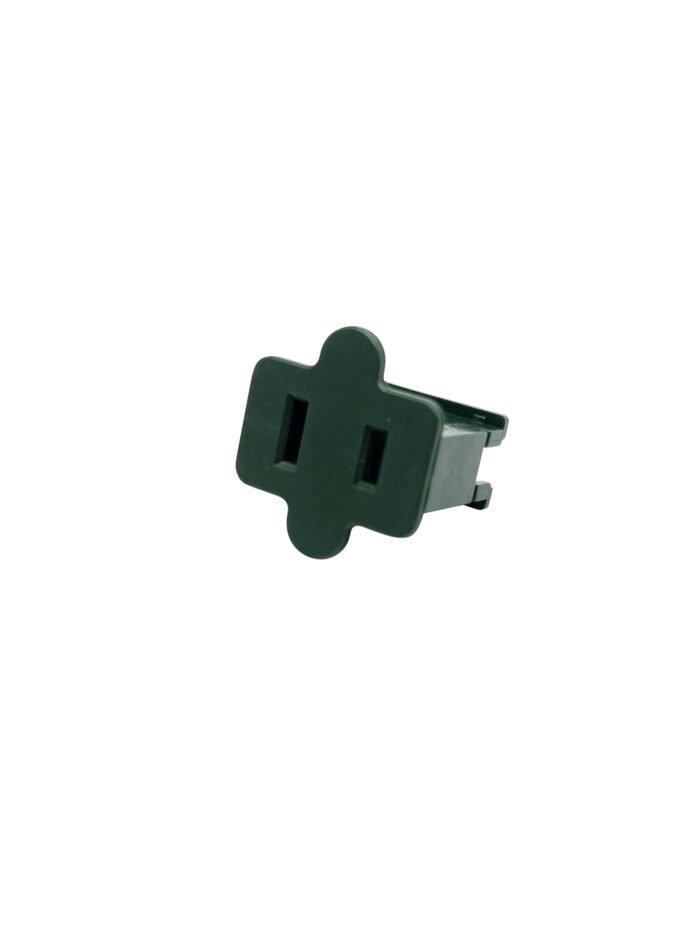 A green plastic electrical adapter with a cross-shaped design, featuring two elongated rectangular prongs for inserting into a power outlet. Perfect for setting up outdoor Christmas lights, the adapter appears isolated on a white background.