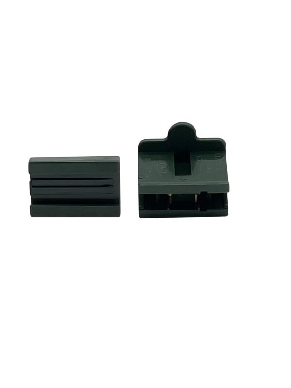 The image shows two black plastic components. The left component is a rectangular piece with a slotted design. The right component, often used by Christmas light contractors, is similarly shaped but open, revealing internal details and connectors, suggesting it serves as housing or casing for the left piece.